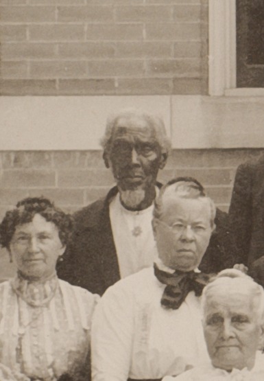 Isaac Lewis Manning standing at the back of a historical group photograph